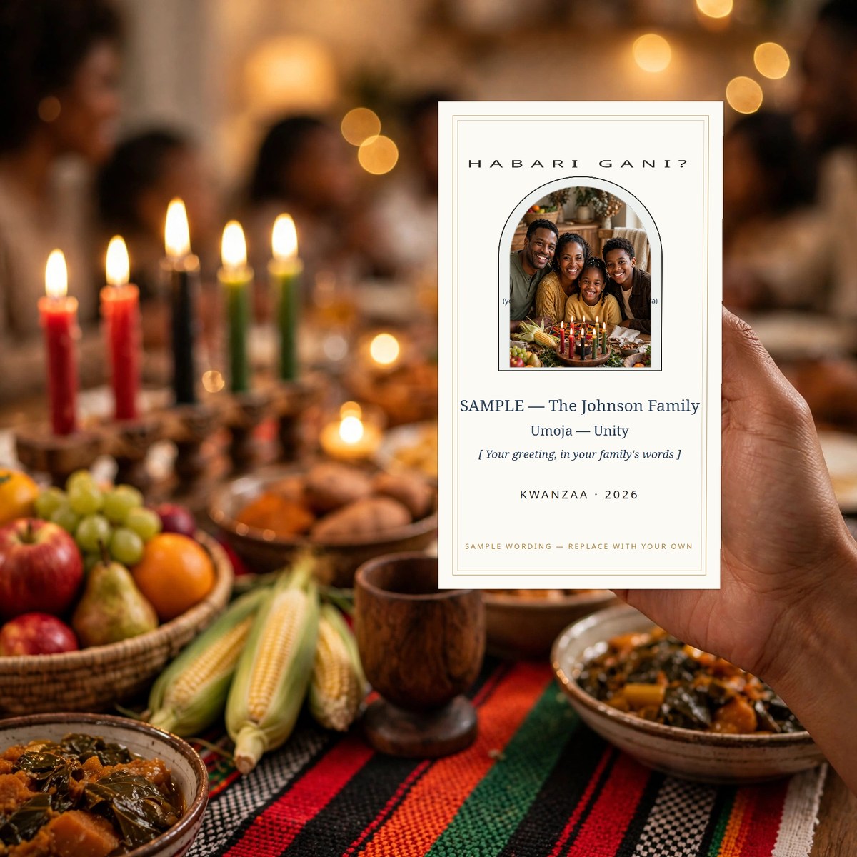 Hand holding a phone showing a Kwanzaa greeting card with the family's own photo and the day's principle named, the family's own kinara on the table behind it